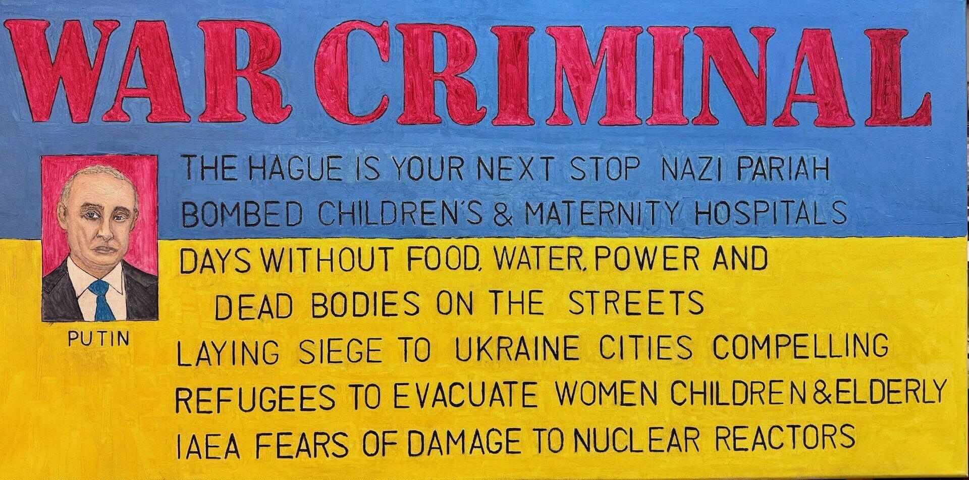 A protest sign condemning war crimes in Ukraine, highlighting civilian suffering and nuclear threats.